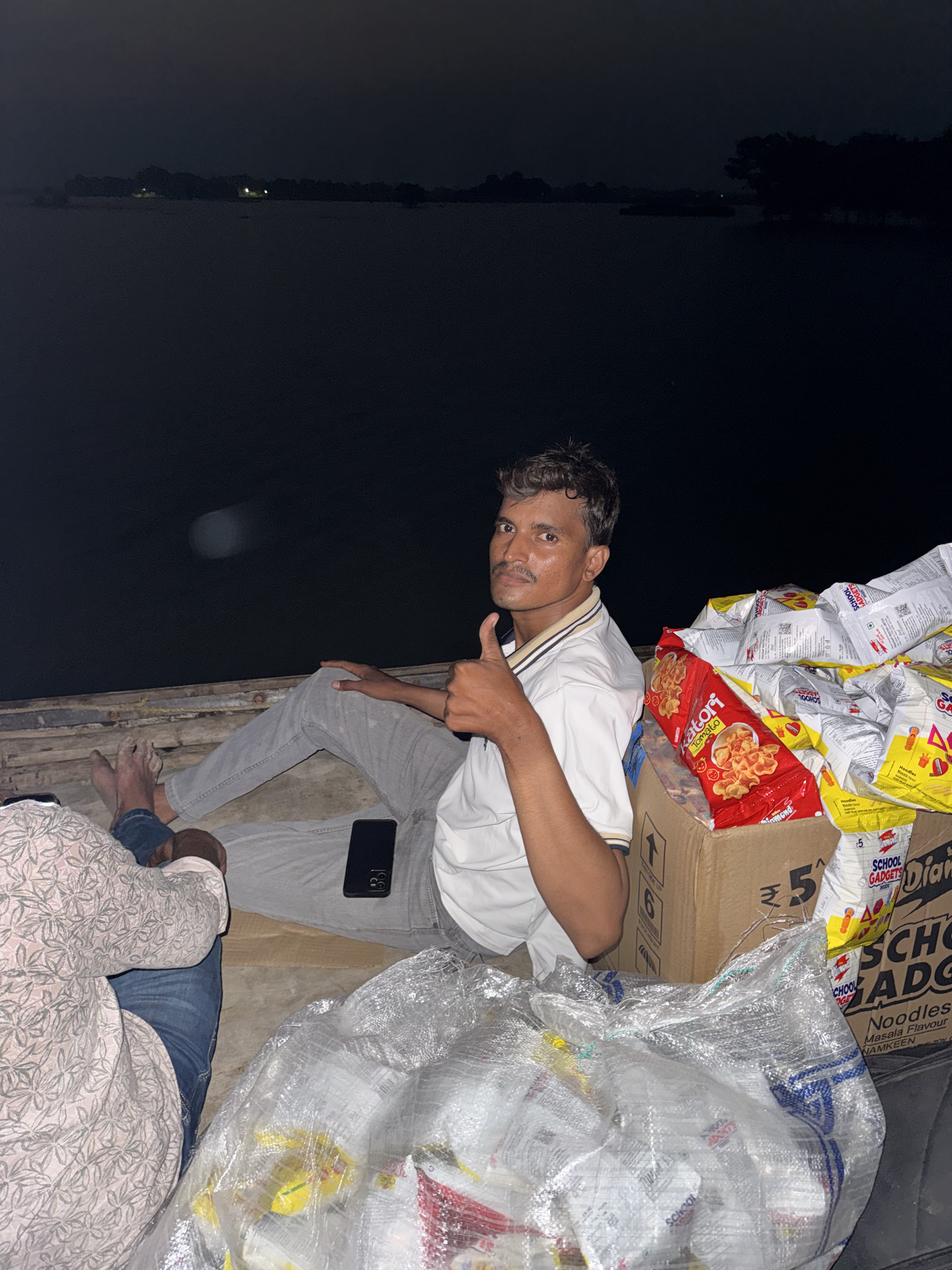 Volunteer with flood-relief supplies on a boat